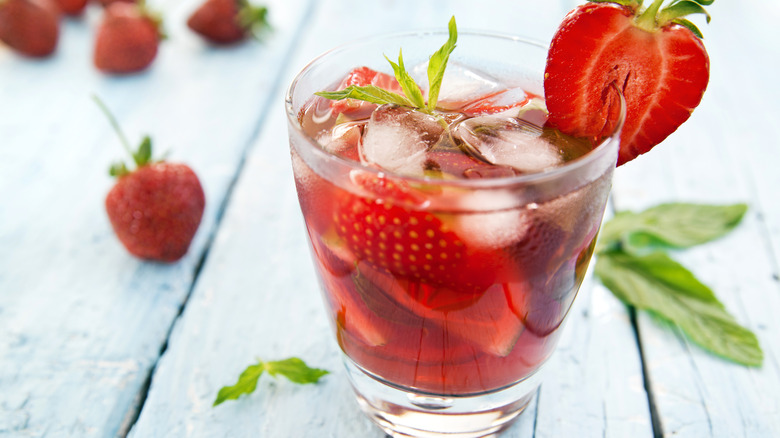 Red beverage garnished with strawberry