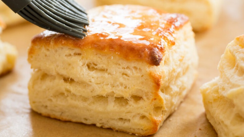 brushing biscuit with melted butter