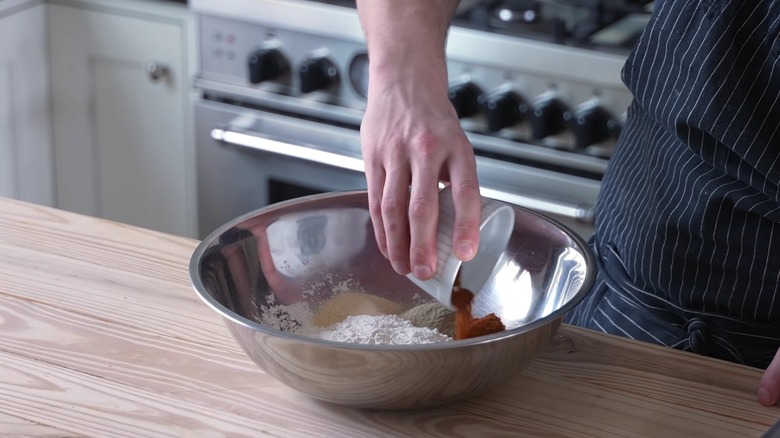 Chef seasoning a batter