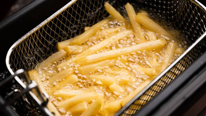 potatoes frying in deep fryer