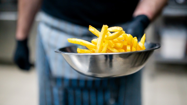 chef holding french fries