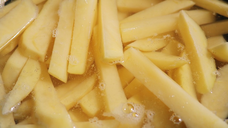 raw french fries in water