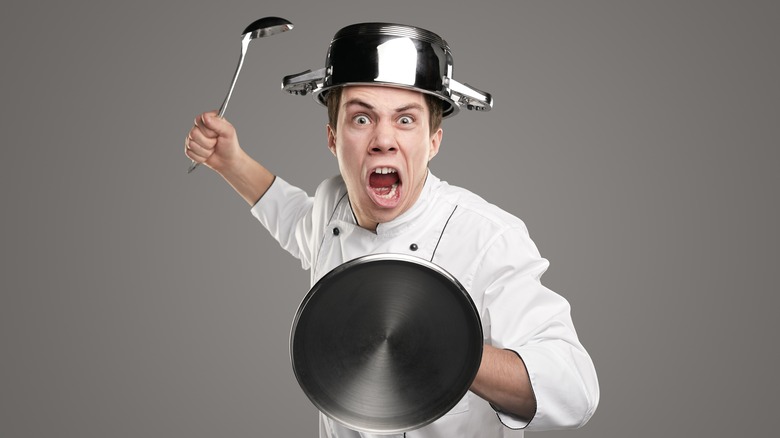 angry chef with pot on head