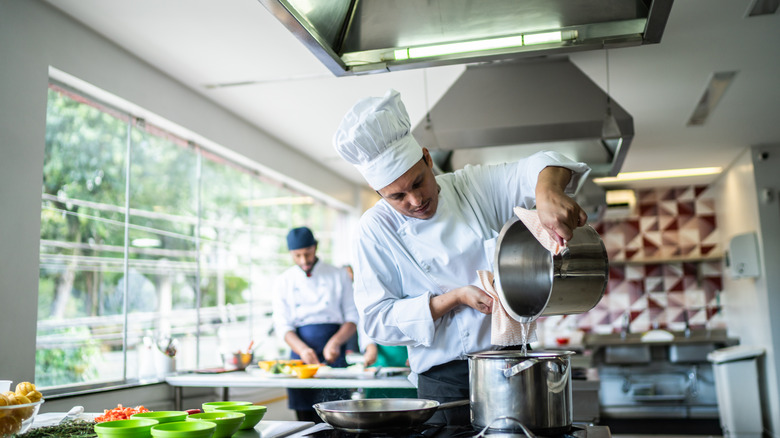 chefs prepping food in kitchen