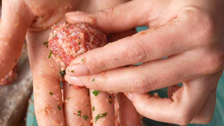 Hands shaping meatball