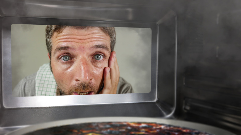 Man gazing into microwave