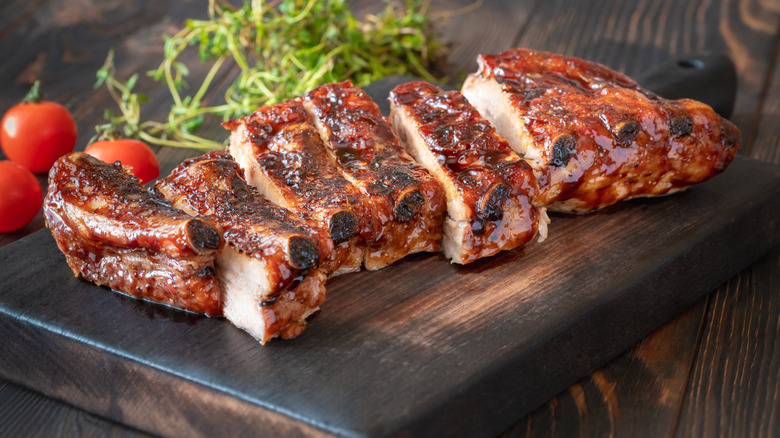 juicy ribs with barbecue sauce on a cutting board