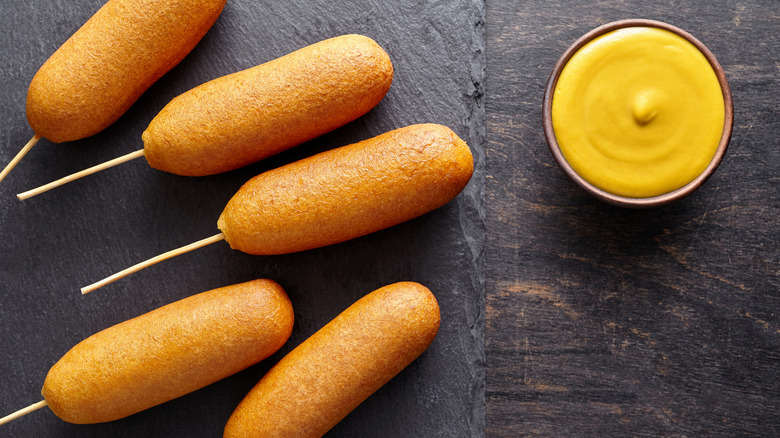 corn dogs with ramekin of mustard