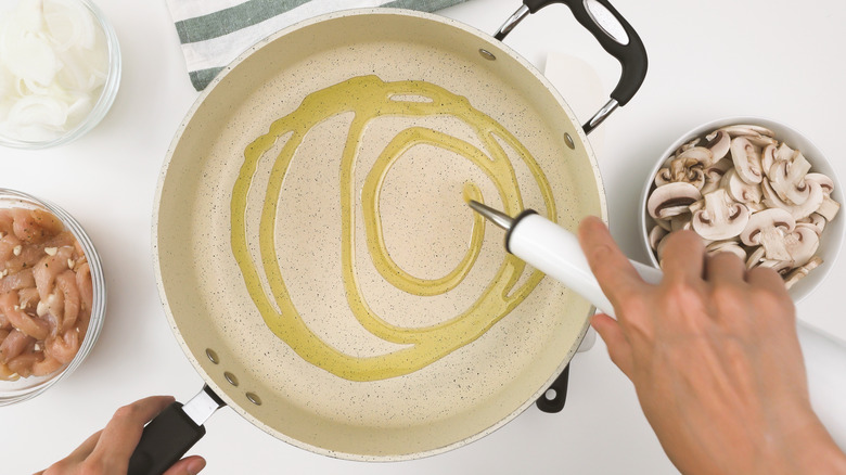 Olive oil being drizzled in a pan