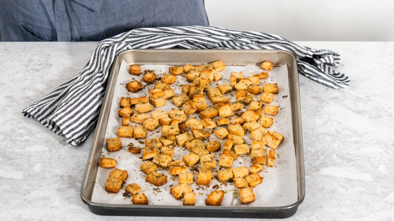 Seasoned croutons on baking pan