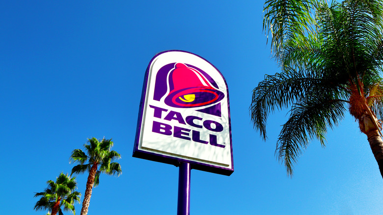 Outside Taco Bell sign with palms