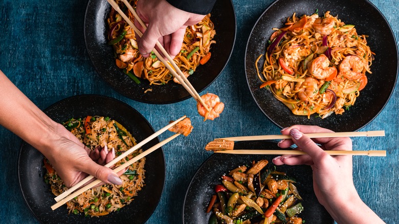 hands with chopsticks Thai food