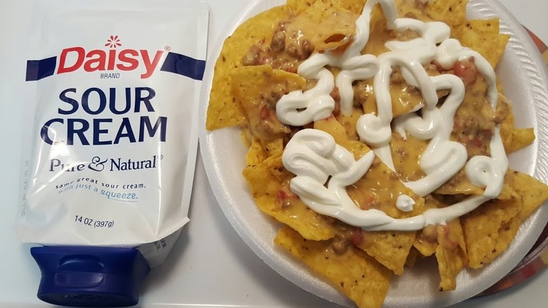 sour cream squeezed on nachos