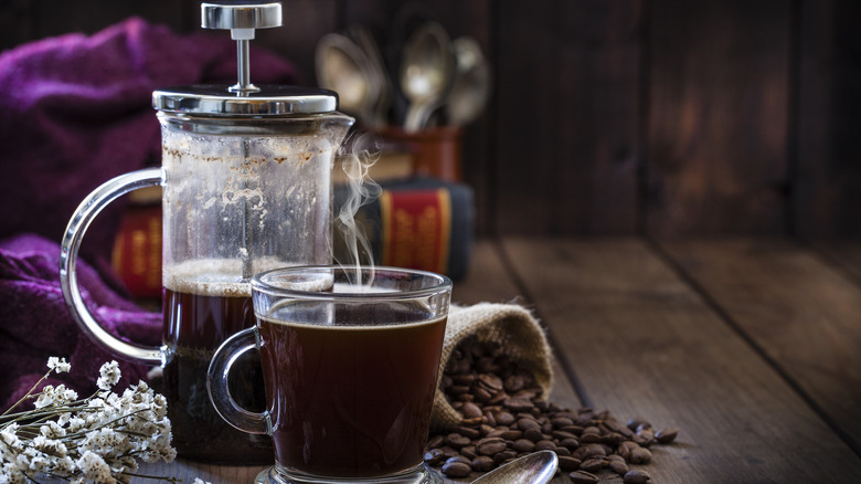 French press by cup of coffee