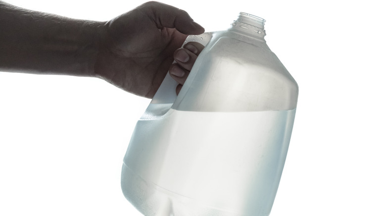 hand holding water jug