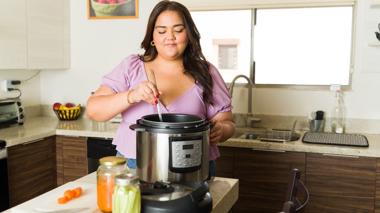 woman cooking a meal in slow cooker