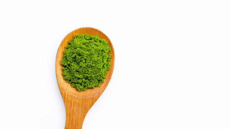 Plankton powder on a spoon on a white background