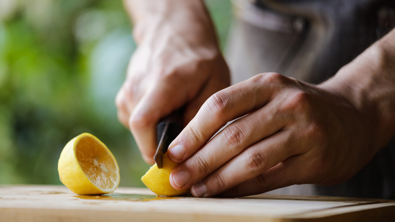 Slicing lemons on a board