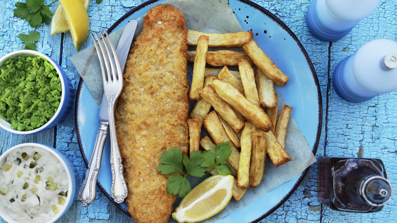 Fried fish with French fries on plate