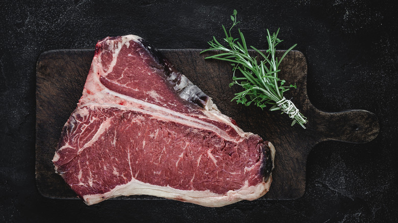 bone-in steak on cutting board