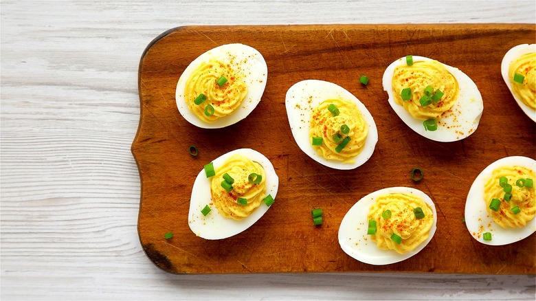 Deviled eggs on wooden platter 