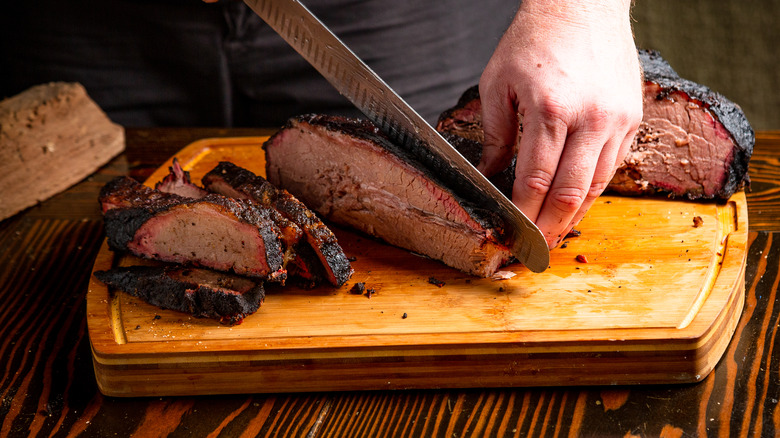 A person cutting meat