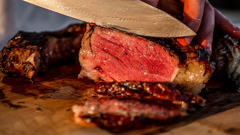 slicing a juicy steak