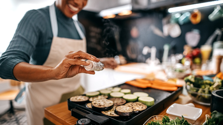 Person griling eggplant