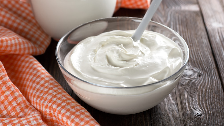 Sour cream on wooden table