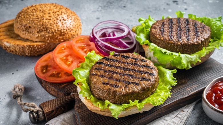 Burger patties on a wooden board