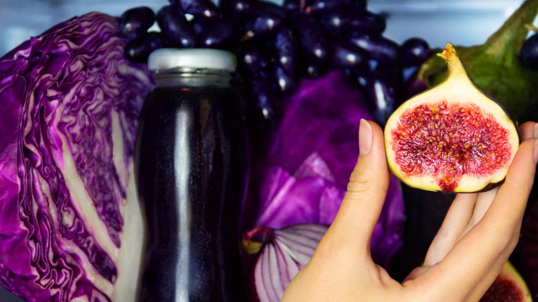 Person holding fig in front of fridge