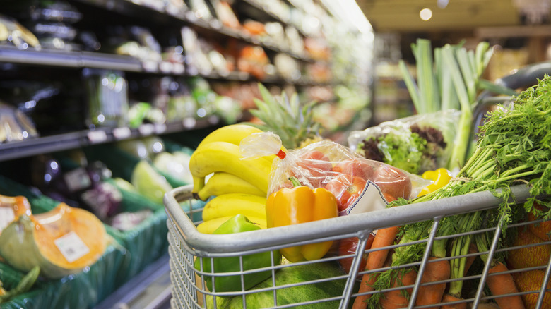 Cart full of fresh produce in grocery store