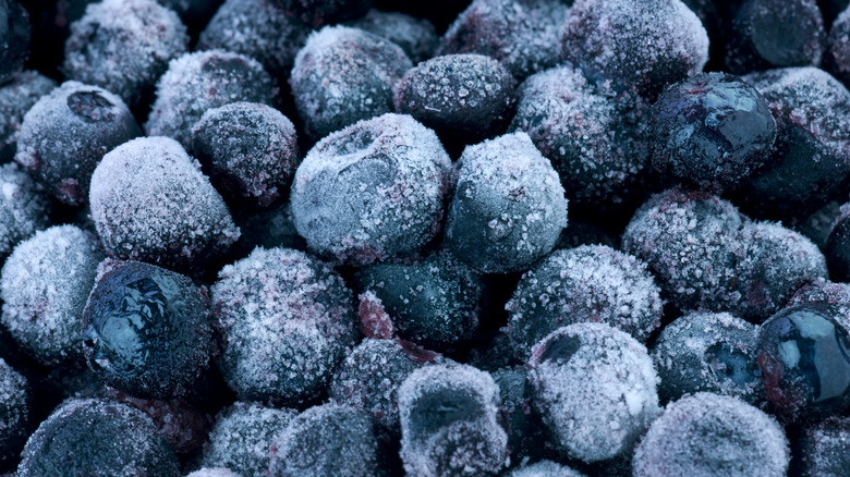 Pile of frozen blueberries against a black background