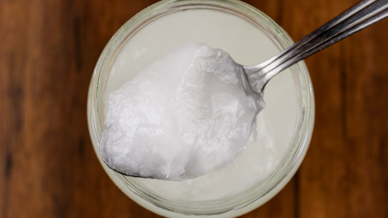 Spoonful of coconut oil over jar