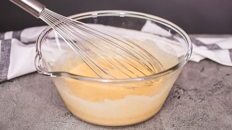 Mixing cornbread batter in a bowl