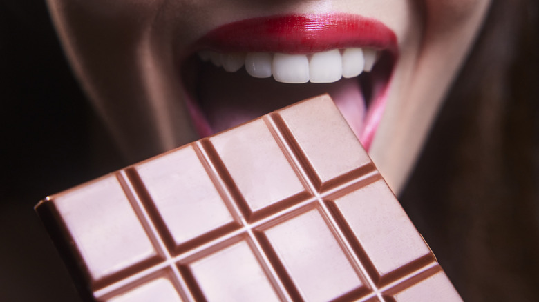 woman biting chocolate 