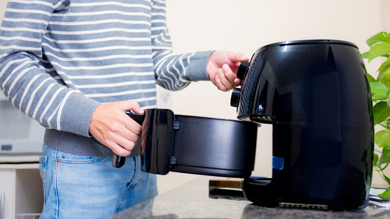 man using air fryer