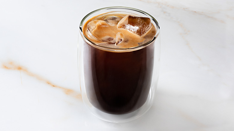 Iced coffee on white marble.