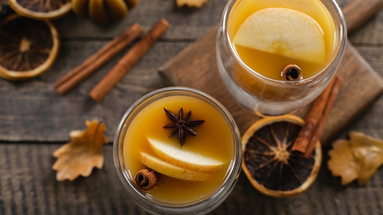 top-down shot of two hot apple cider glasses