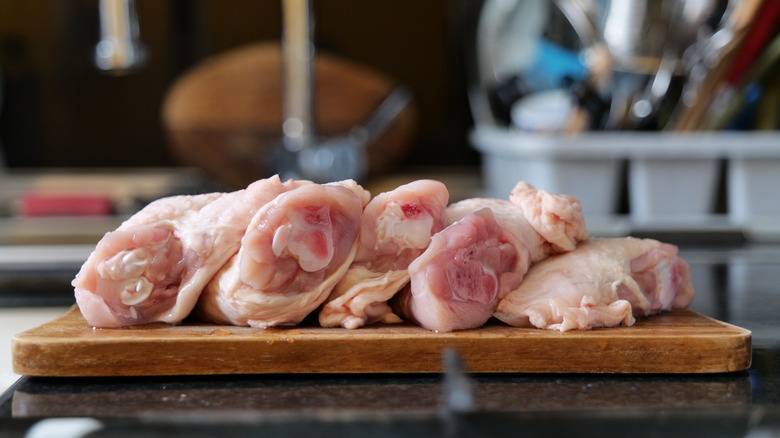 Raw chicken on cutting board