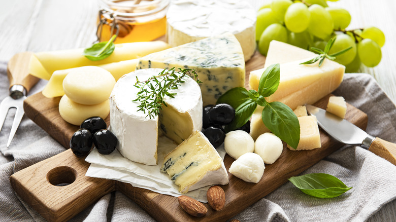 Various types of cheese on board.