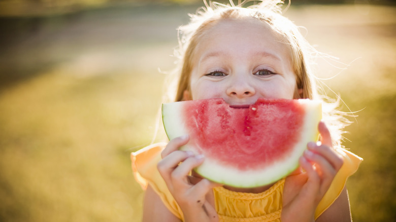 child eating watermelon