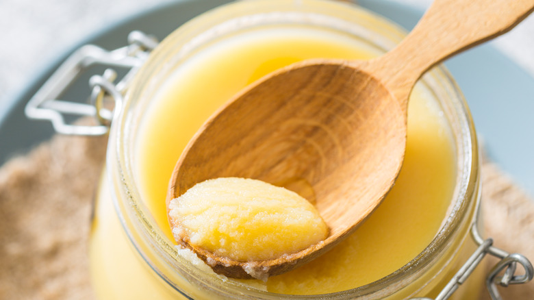 Canned butter on wooden spon