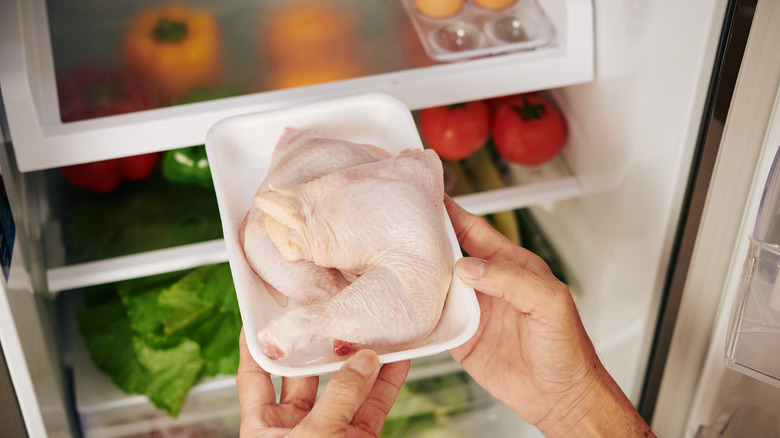 packaged chicken entering fridge