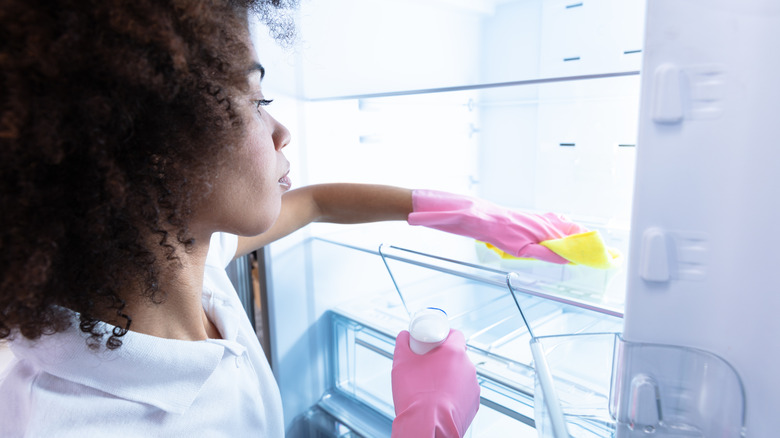 woman cleaning refrigerator