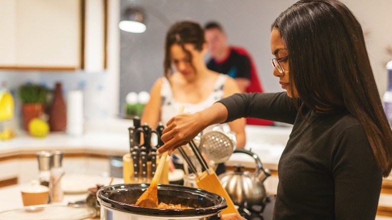 person using a slow cooker