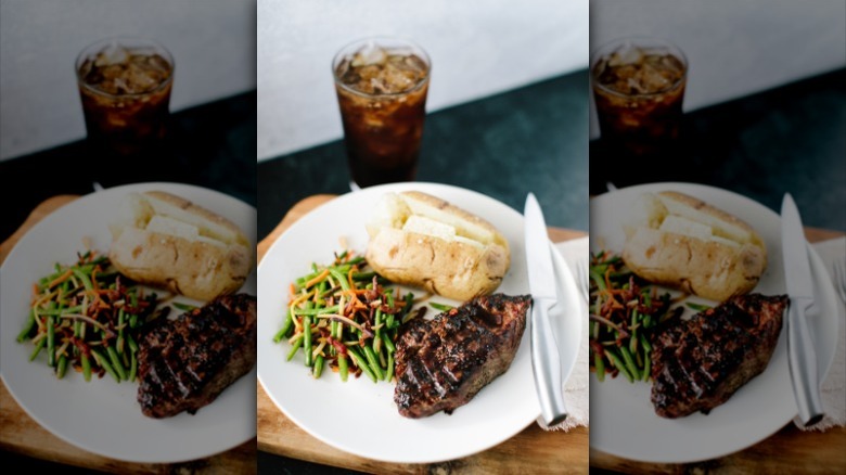 steak dinner with soda