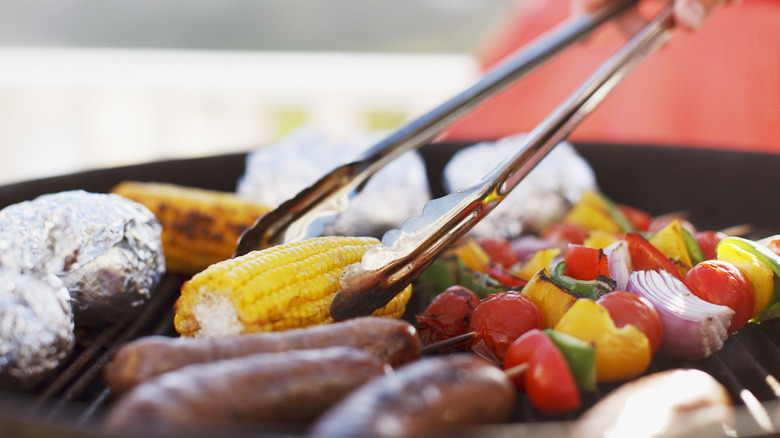 vegetables on the grill with tongs