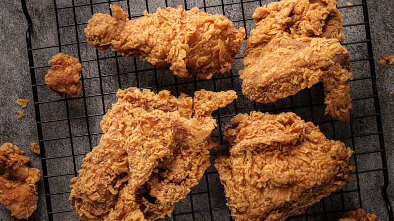 crispy homemade fried chicken peices on a cooling rack