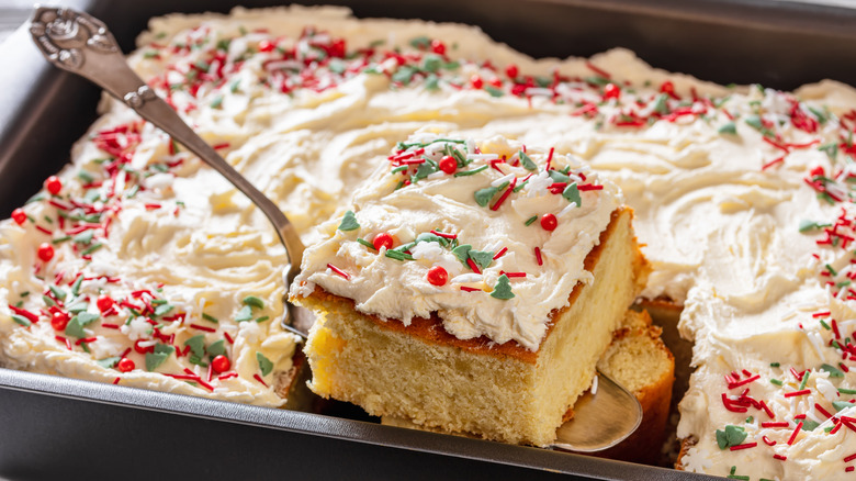 slice of vanilla sheet cake being served